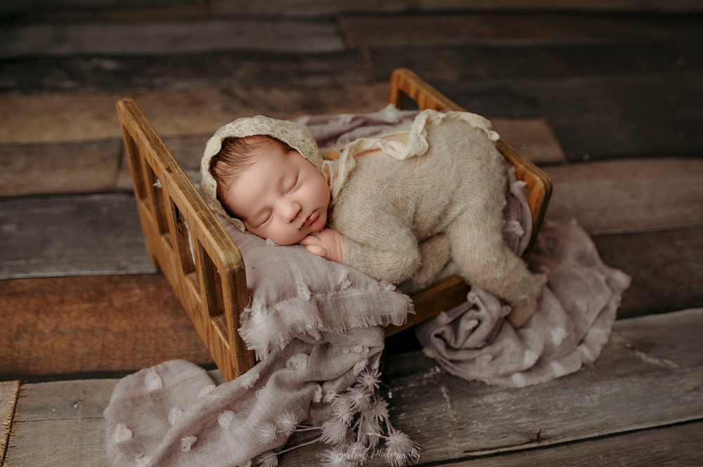 Baltimore newborn photographer Jussara with posed baby in Bel Air studio