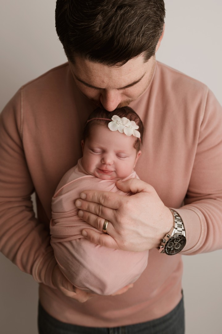 Dad holding newborn baby girl Baltimore newborn photographer Sugarloaf Photography