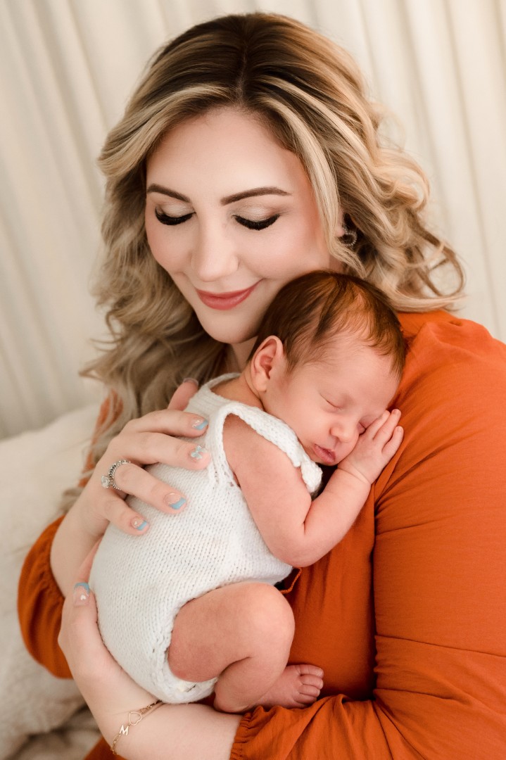 Harford County newborn photographer mom holding newborn studio portrait